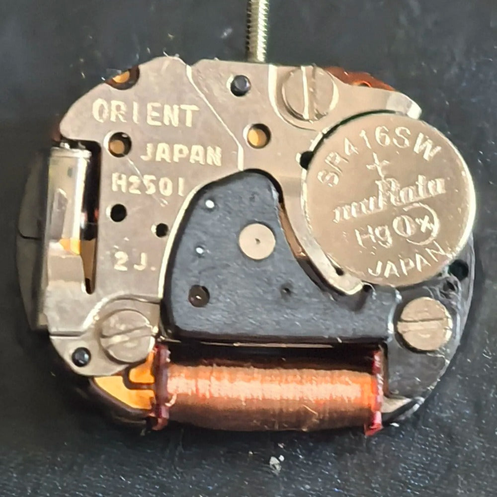 Orient Japan H2501 quartz watch part showing disassembled 3 hands movement for repair and replacement.