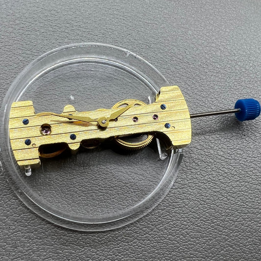 Golden mechanical watch movement with long hands, hand-wound precision