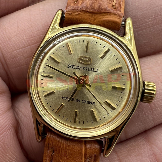 Elegant Tianjin Seagull ladies watch with round golden case and manual mechanical movement, perfect for refined style.