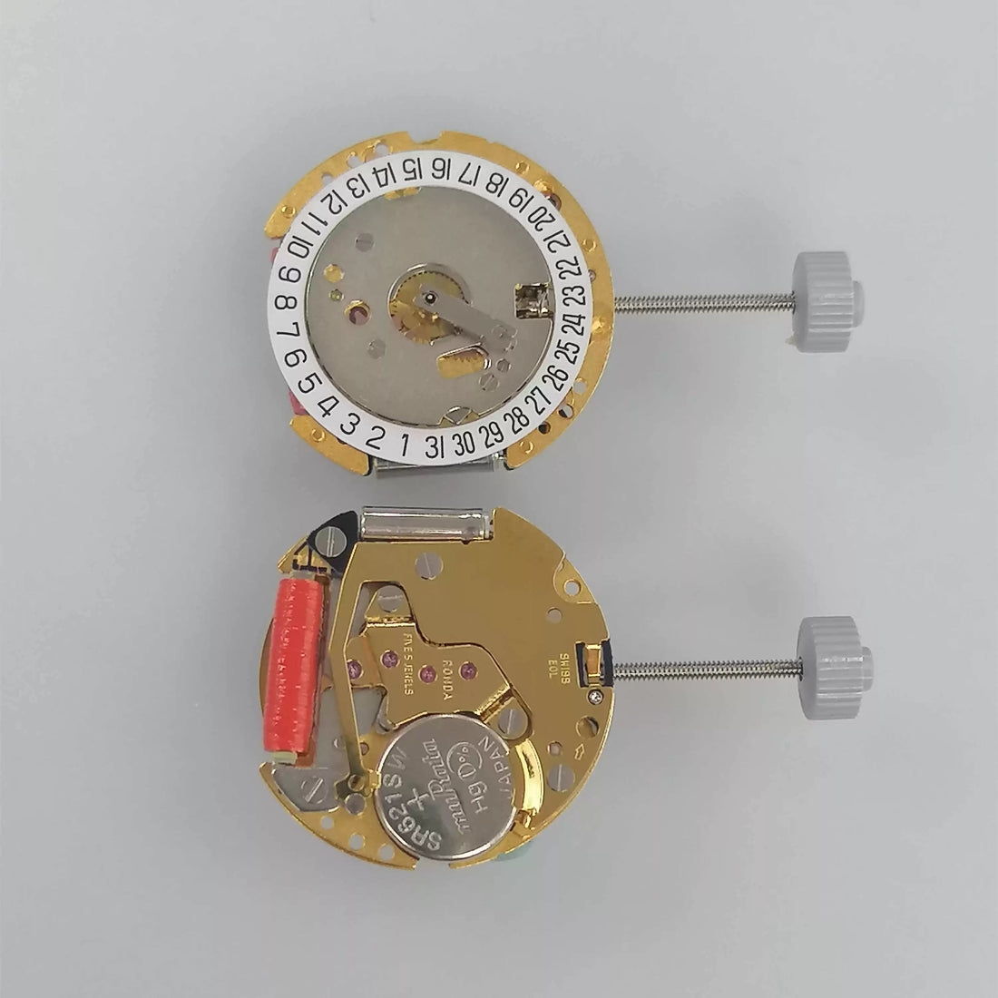 Swiss Made Ronda 775 quartz movement with white date disk at 6 o'clock, precise watch part.