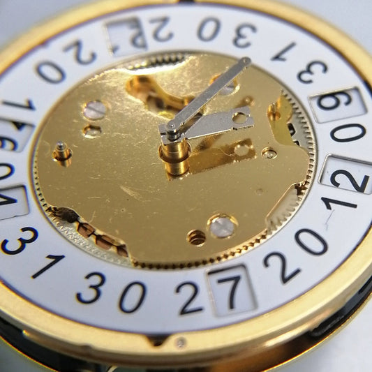 Swiss Made Ronda 5020.B quartz movement for golden watch, precision timekeeping by Ronda brand.