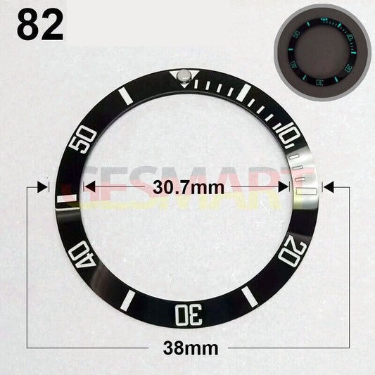 38mm black ceramic watch bezel with silver font and green luminous details, perfect for precision timepieces.