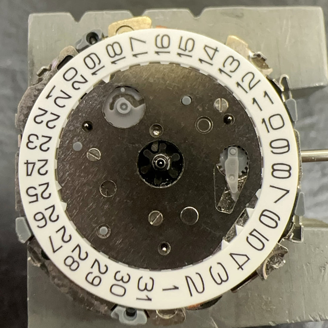 Close-up of Japan Made Miyota FS01 Lady Quartz watch movement repair part showing date display at 4 o?clock position.