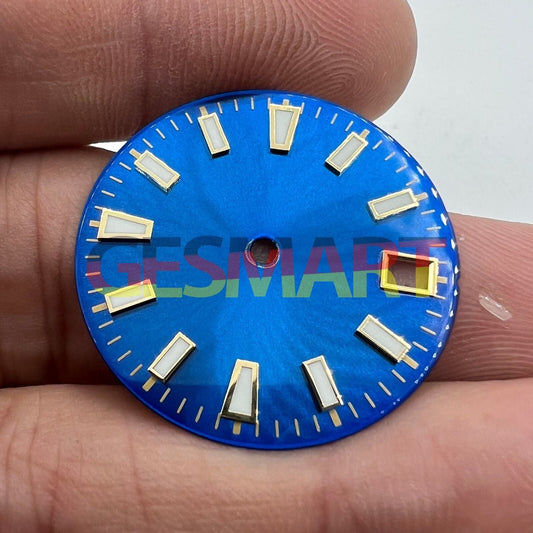 Green luminous watch dial with blue and gold nail trim, designed for NH35 movement, enhancing timepiece clarity.