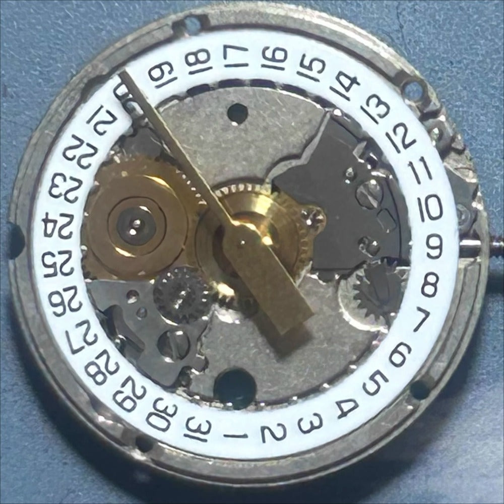 Swiss Made ETA956.114 quartz movement watch part with white disk and 3 hands for precise timekeeping.