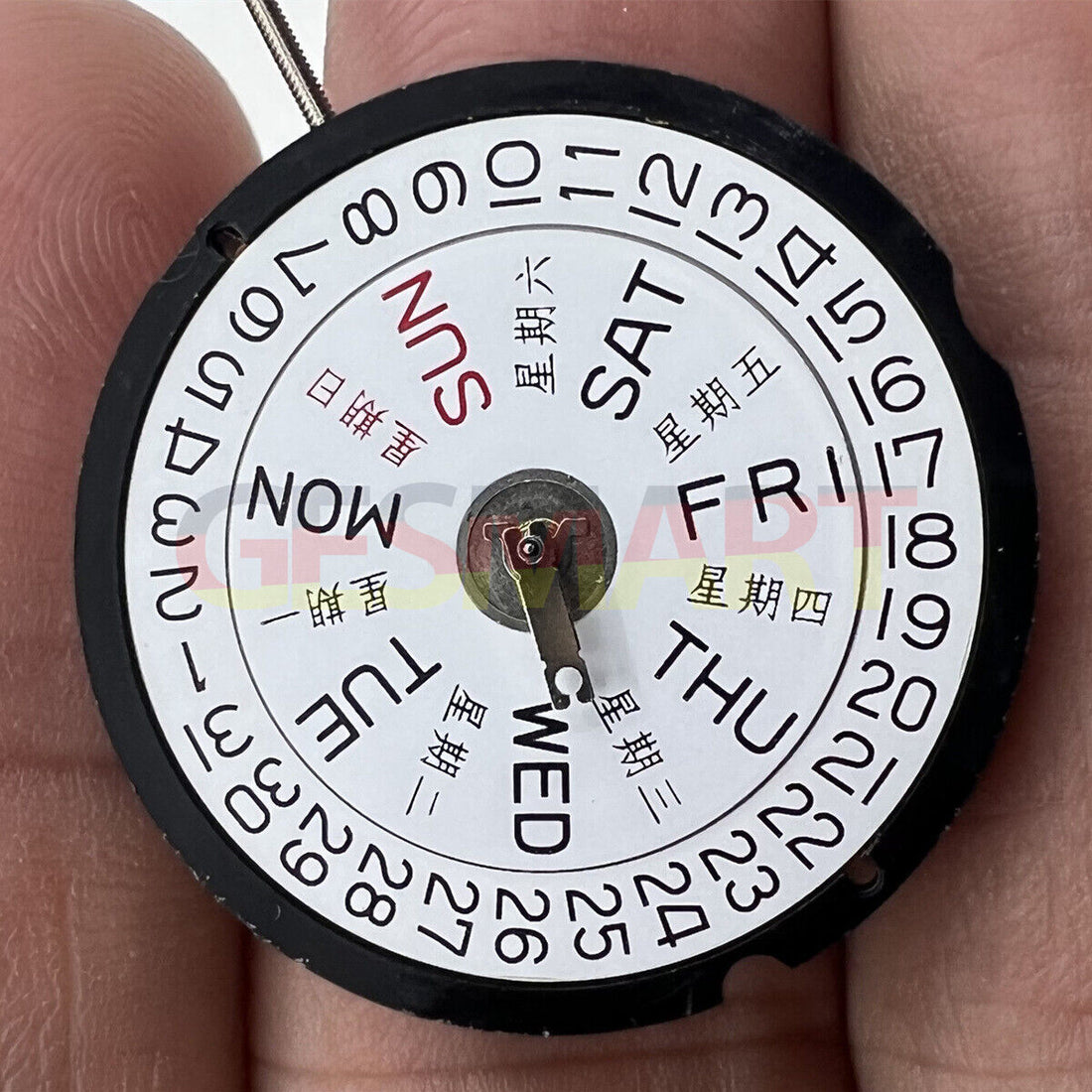 Ronda 517 quartz watch movement showing English & Chinese day and date display at 3 o'clock, Swiss parts.