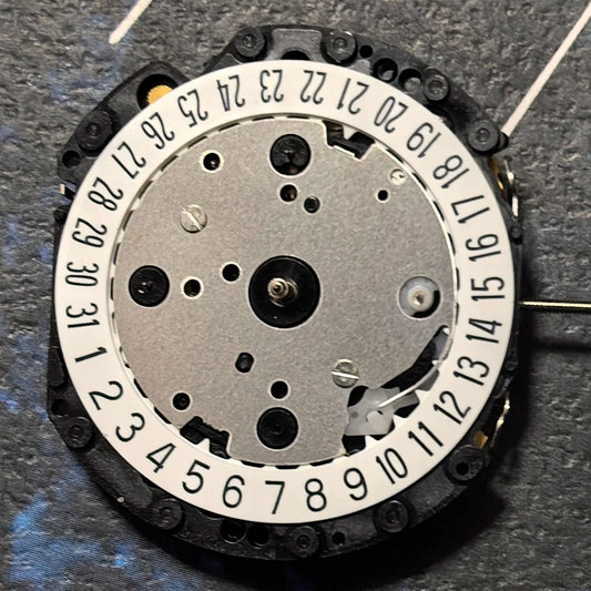 Epson VD52 quartz watch movement with 6 hands, date at 6, and small seconds at 3/9/12 positions.