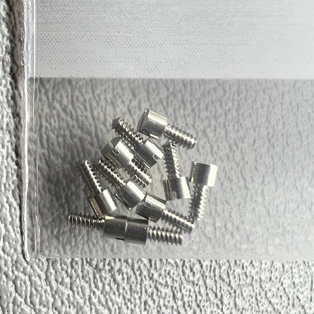 1. Set of 10 watch dial feet screws for China 7120 movement, compatible with various watch repairs.  
