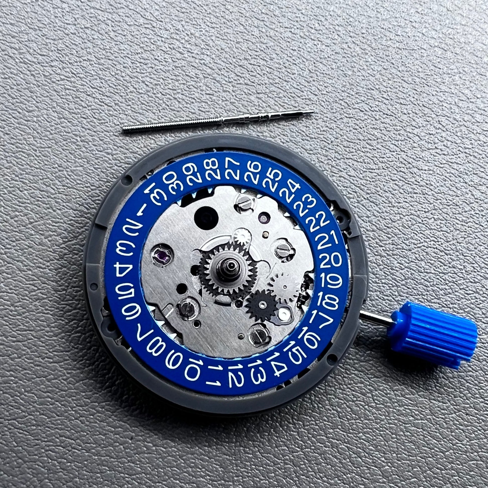 Seiko NH34 mechanical GMT watch movement with blue disk and white font for accurate timekeeping.