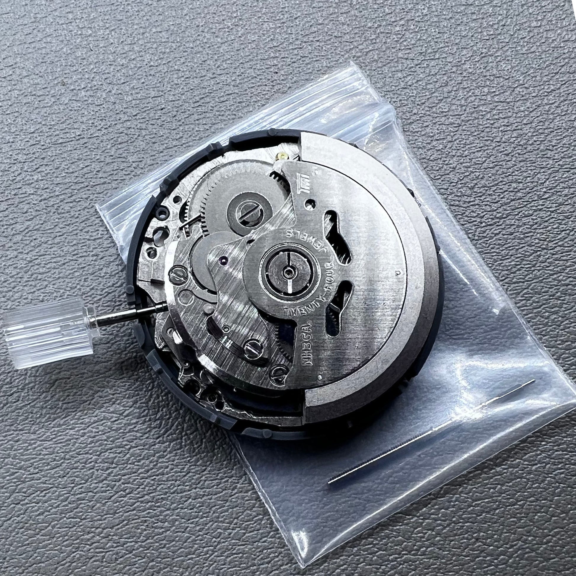 Seiko NH36 watch movement with black dial, Arabic numerals, date display, crown at 3:00 position