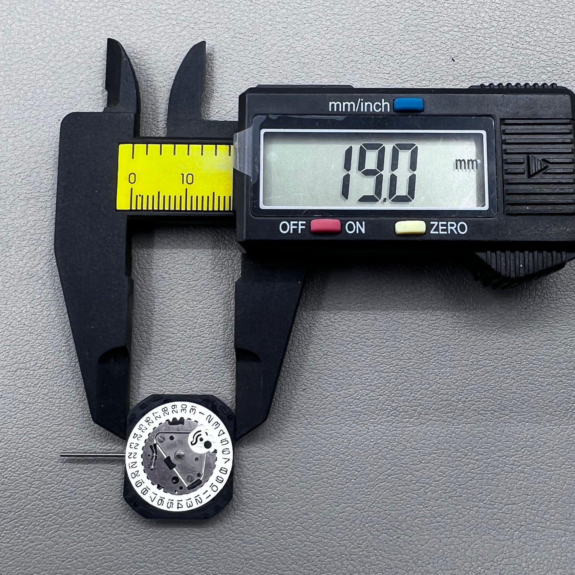 Japan VX22 quartz watch movement with date at 3 o'clock, white disk replacement for precision.