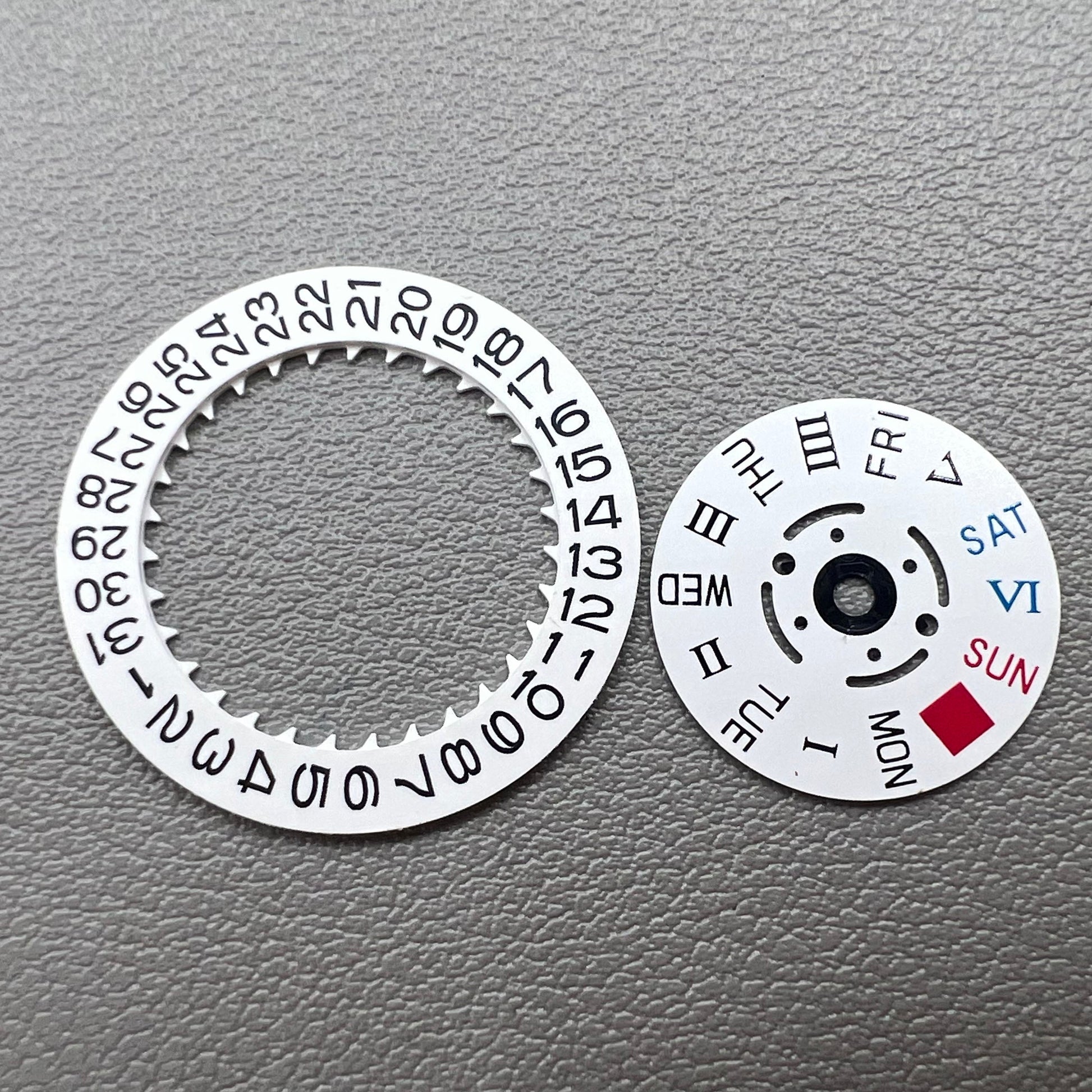 White date display with Roman and English weekday wheel for NH36 movement, crown at 3 o'clock.