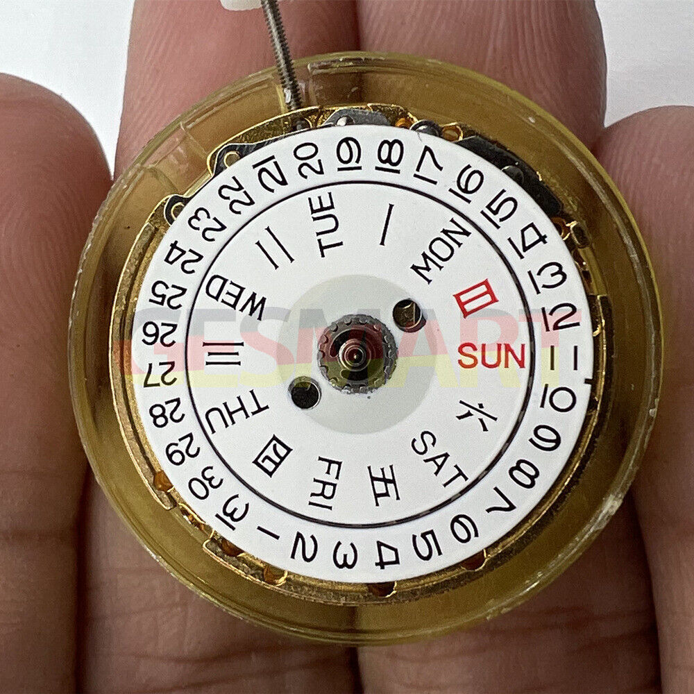 DG2813 automatic mechanical watch movement with golden finish, showing day and date functions.