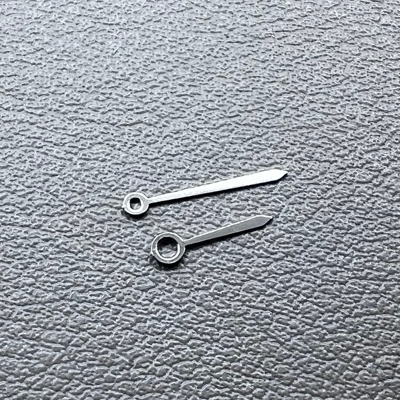 Set of 2 silver 10x7mm watch hands for Ronda 763/762/751/1062/1063 movements, perfect for repairs.