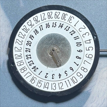 Disassembled Ronda 515B quartz movement showing Swiss precision with 3 hands and double calendar date at 6