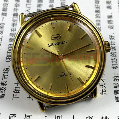 35mm golden case Tianjin Seagull watch with round dial, manual mechanical movement, classic style for elegant wear.
