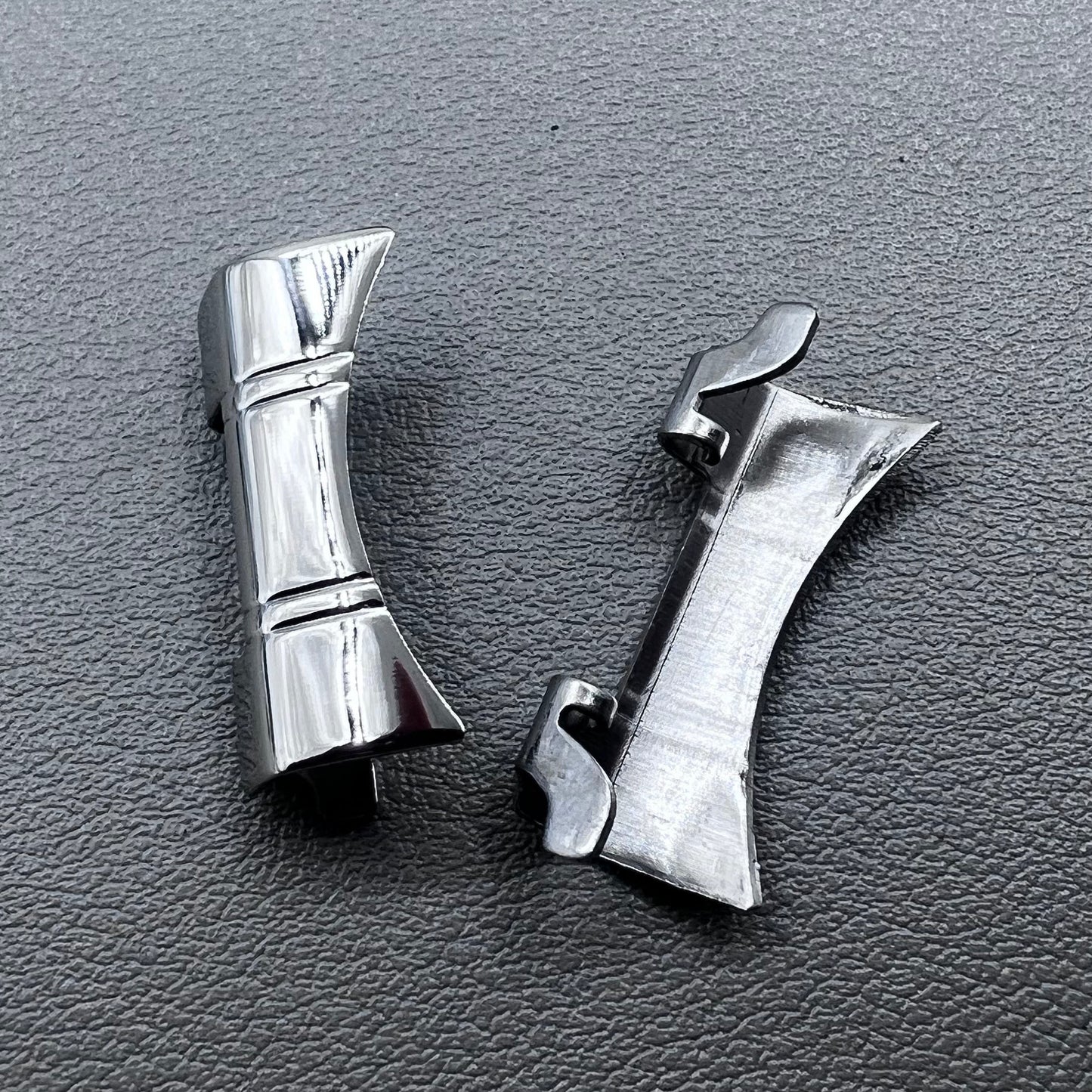 Set of 2 silver steel curved end links with spring bars for 24x12mm watch bands, enhancing bracelet fit.