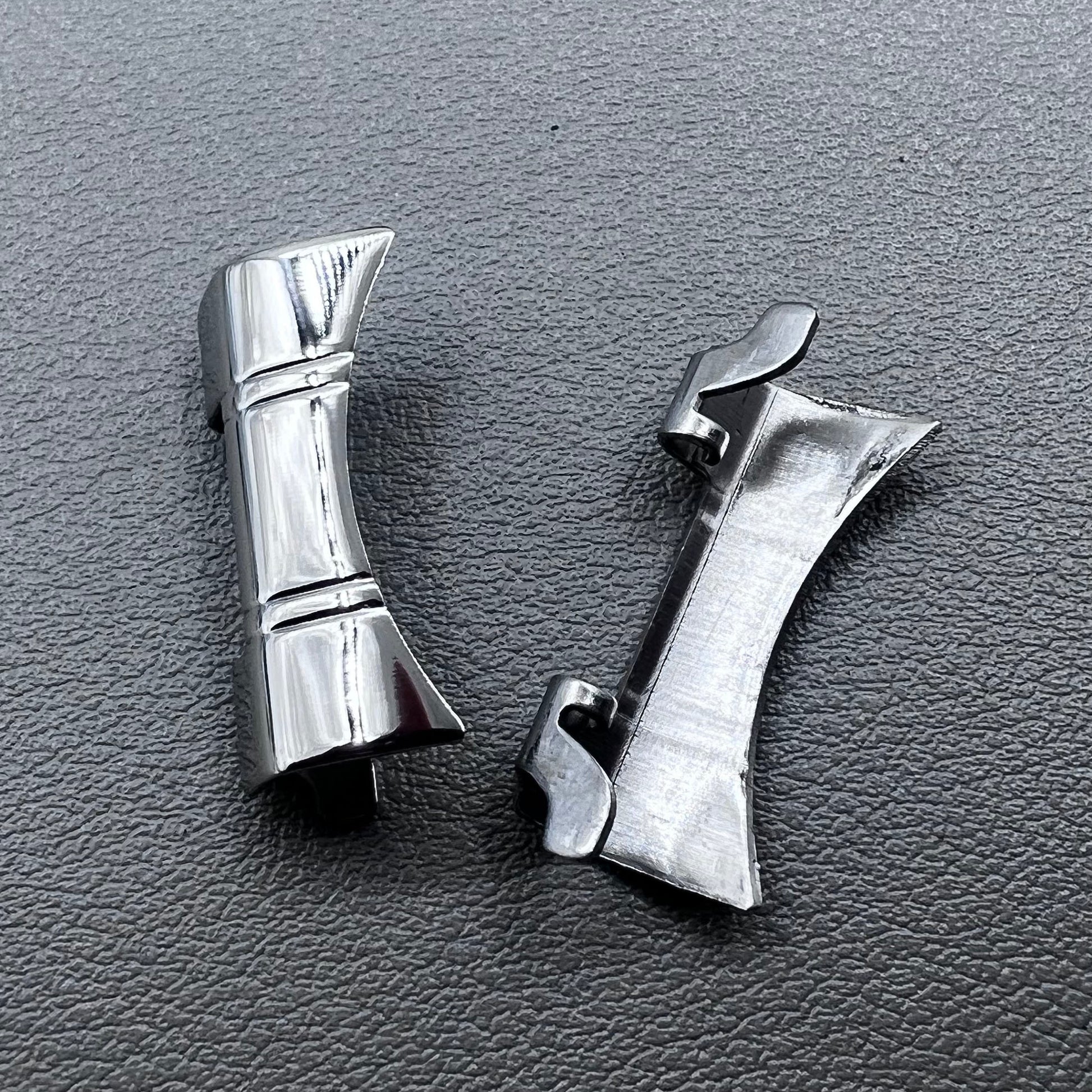 Set of 2 silver steel curved end links with spring bars for 24x12mm watch bands, enhancing bracelet fit.