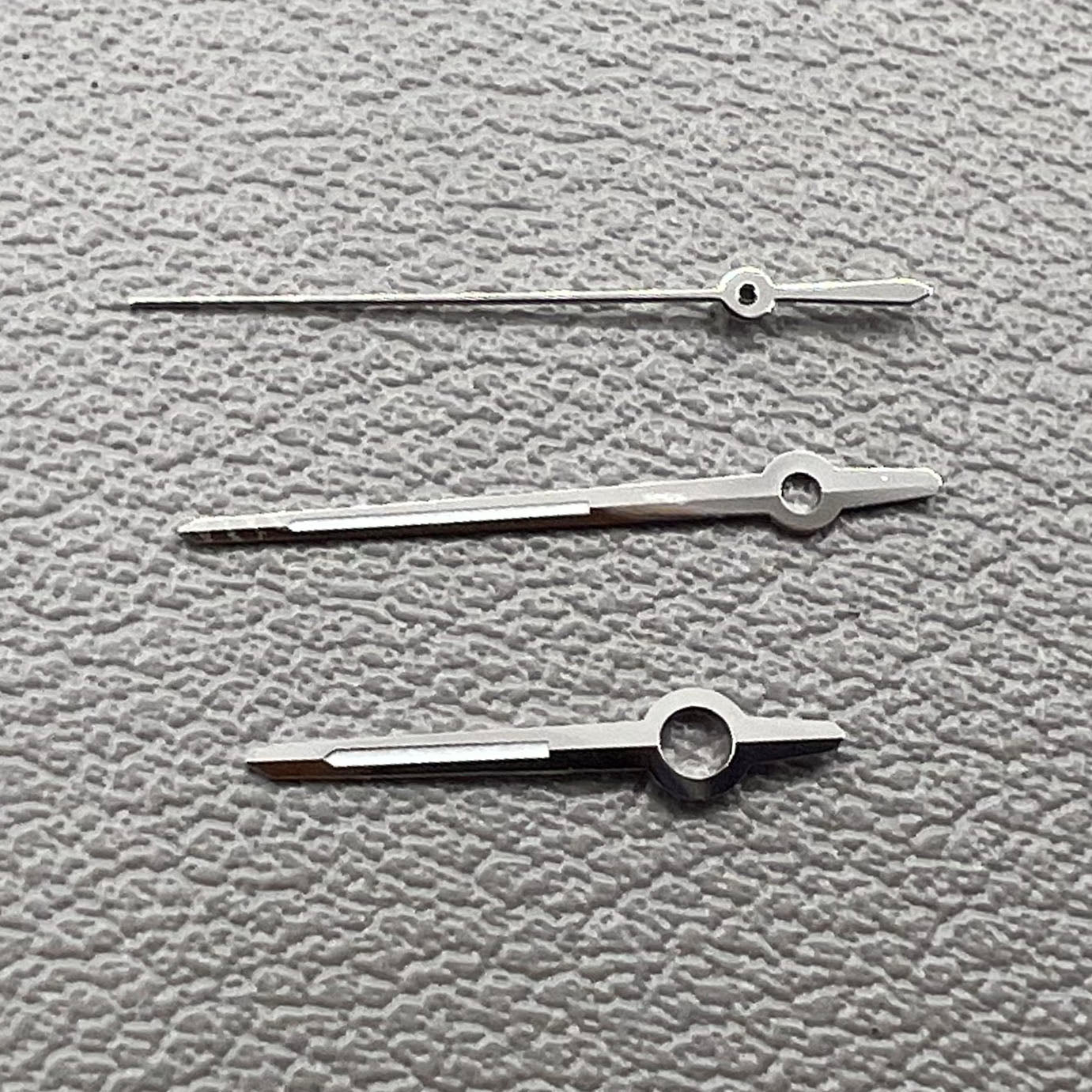 Silver trim watch hands with green luminous tips for ETA 2892, 2846, 2836, 2824 movements, perfect for precise timekeeping.