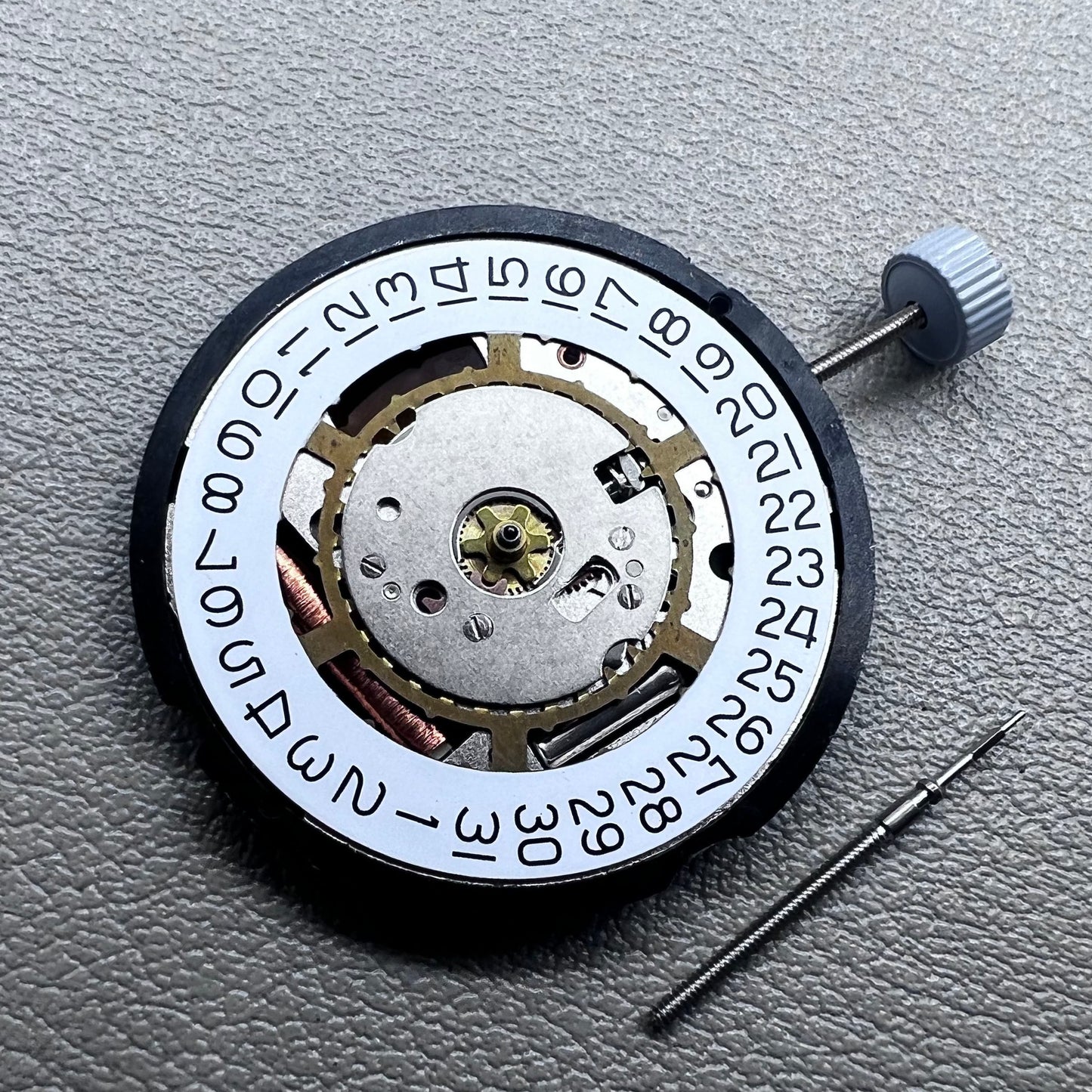 Swiss Ronda 715 quartz watch movement with date display at 3 o'clock, precision timing for accessories.