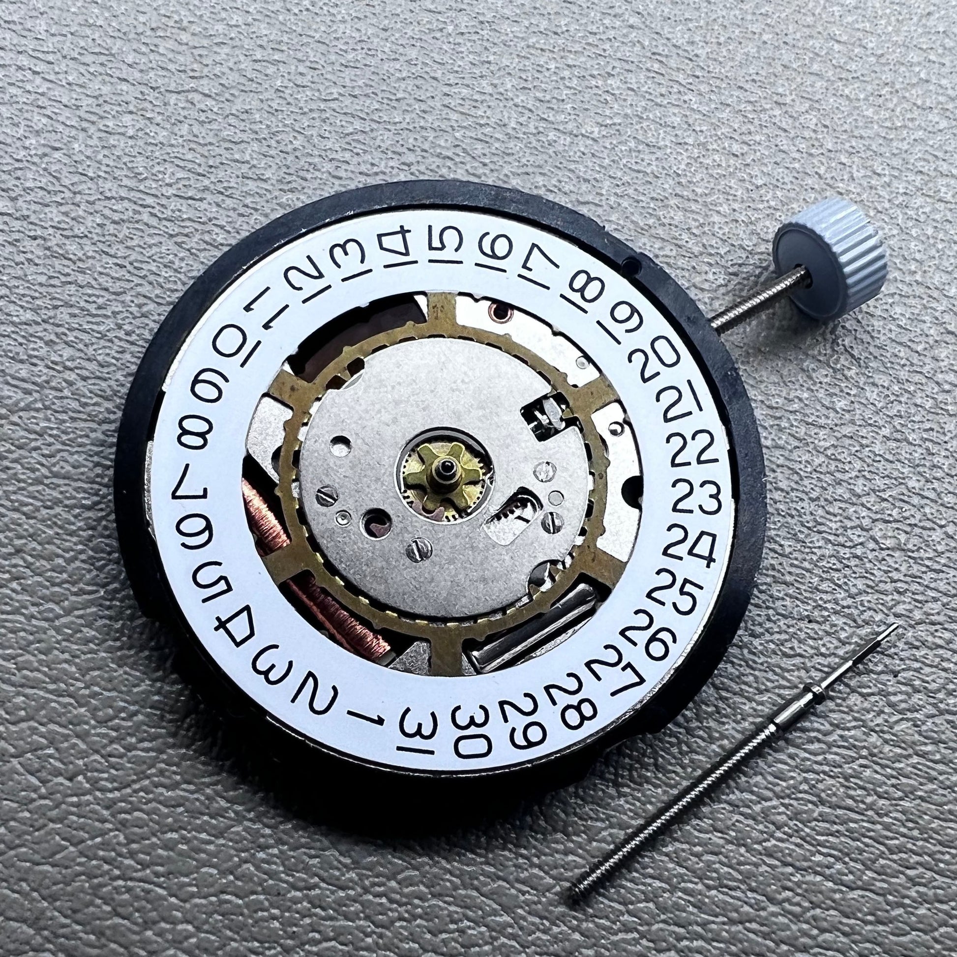 Swiss Ronda 715 quartz watch movement with date display at 3 o'clock, precision timing for accessories.