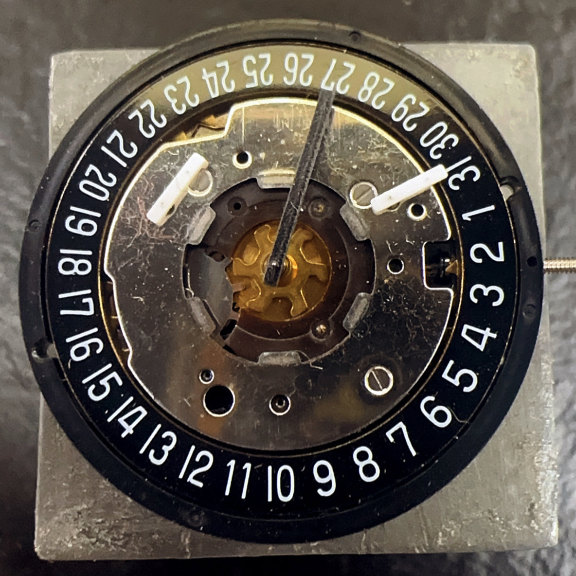 Swiss Made ISA 8271 watch part featuring black disk, multifunctional quartz movement for precision timekeeping.