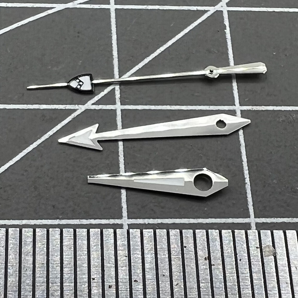 Silver pointed second hand with green lume, compatible with NH35/36 movements, for precise watch repair.