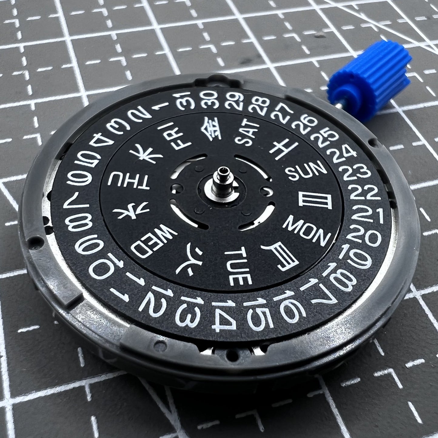 Seiko NH36A automatic watch movement with black finish and green luminescent markers, crown at 3:80 position.