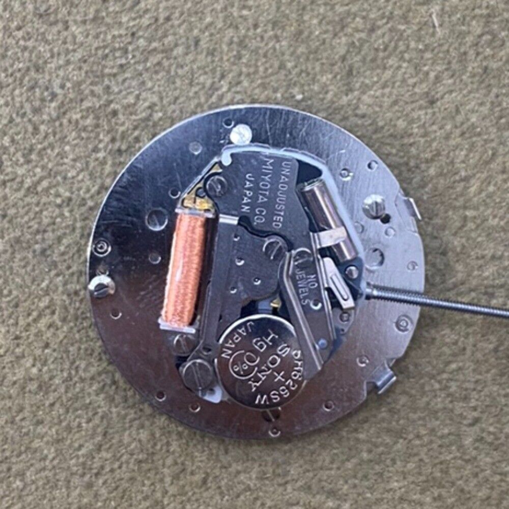 Japan-made Miyota S601 quartz watch movement with small seconds at 3, 6, and 9 o'clock, no calendar.
