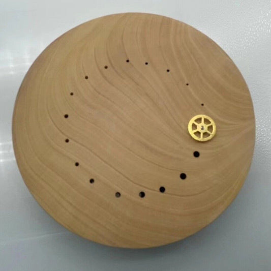 Boxwood watch hand wheel holder for precise balance wheel repair by skilled watchmakers.