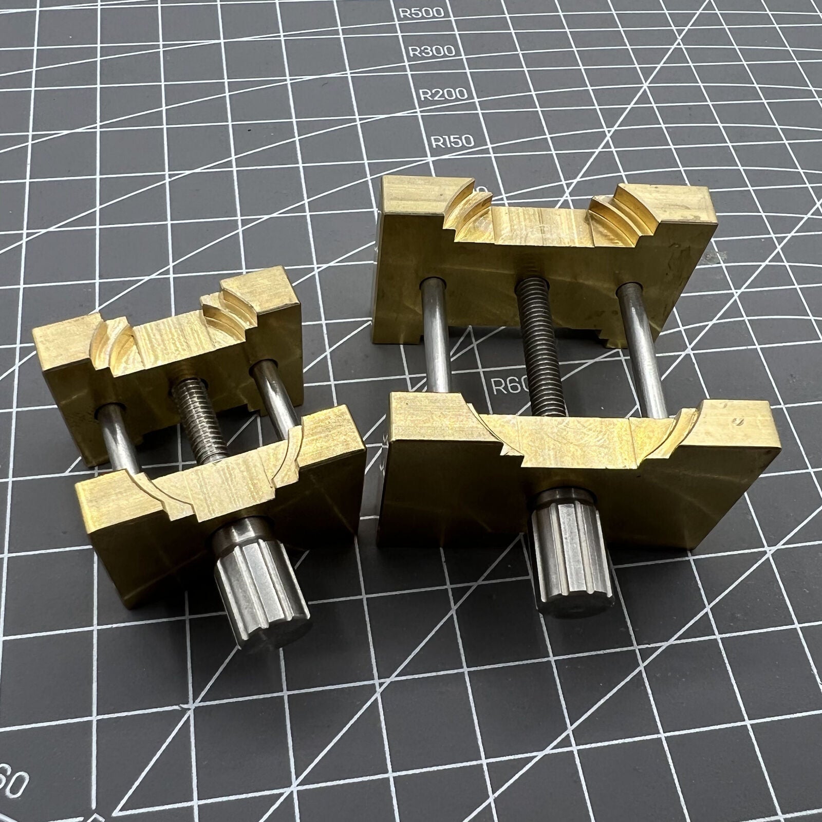 Copper watch movement holder clamp set, ideal for precise vintage watchmaker repairs and maintenance.