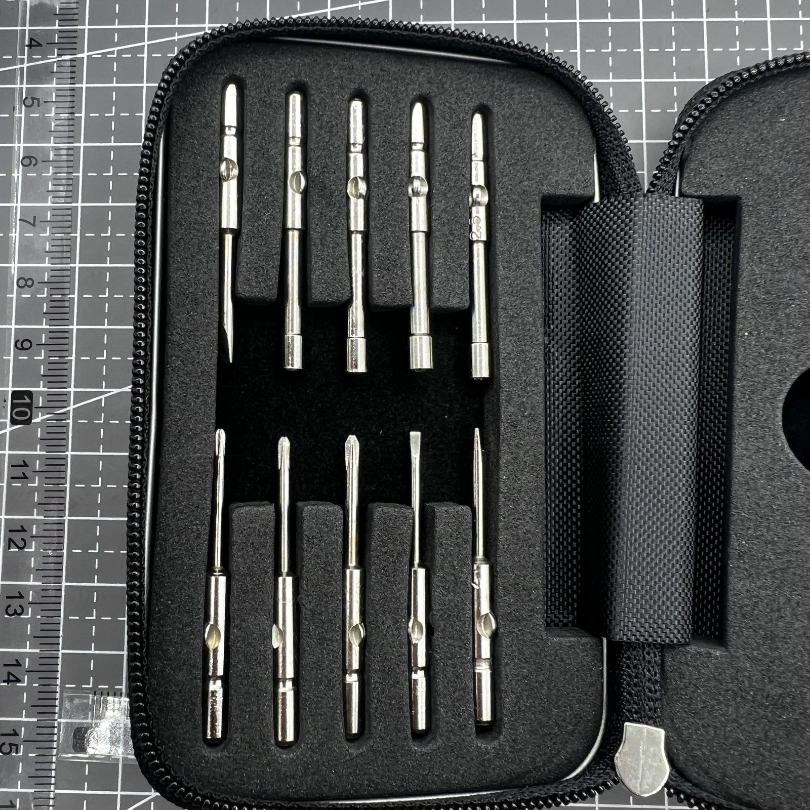 Precision screwdriver set with hex tools for watches and glasses repair, ergonomic grip.