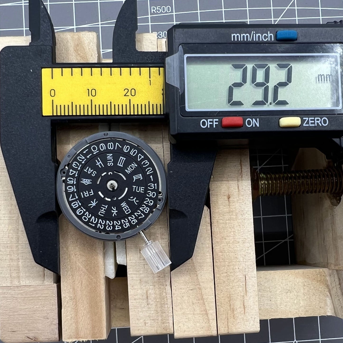 Miyota NH36A automatic watch movement with black finish and blue lume, crown at 3/3.8 position for accuracy.