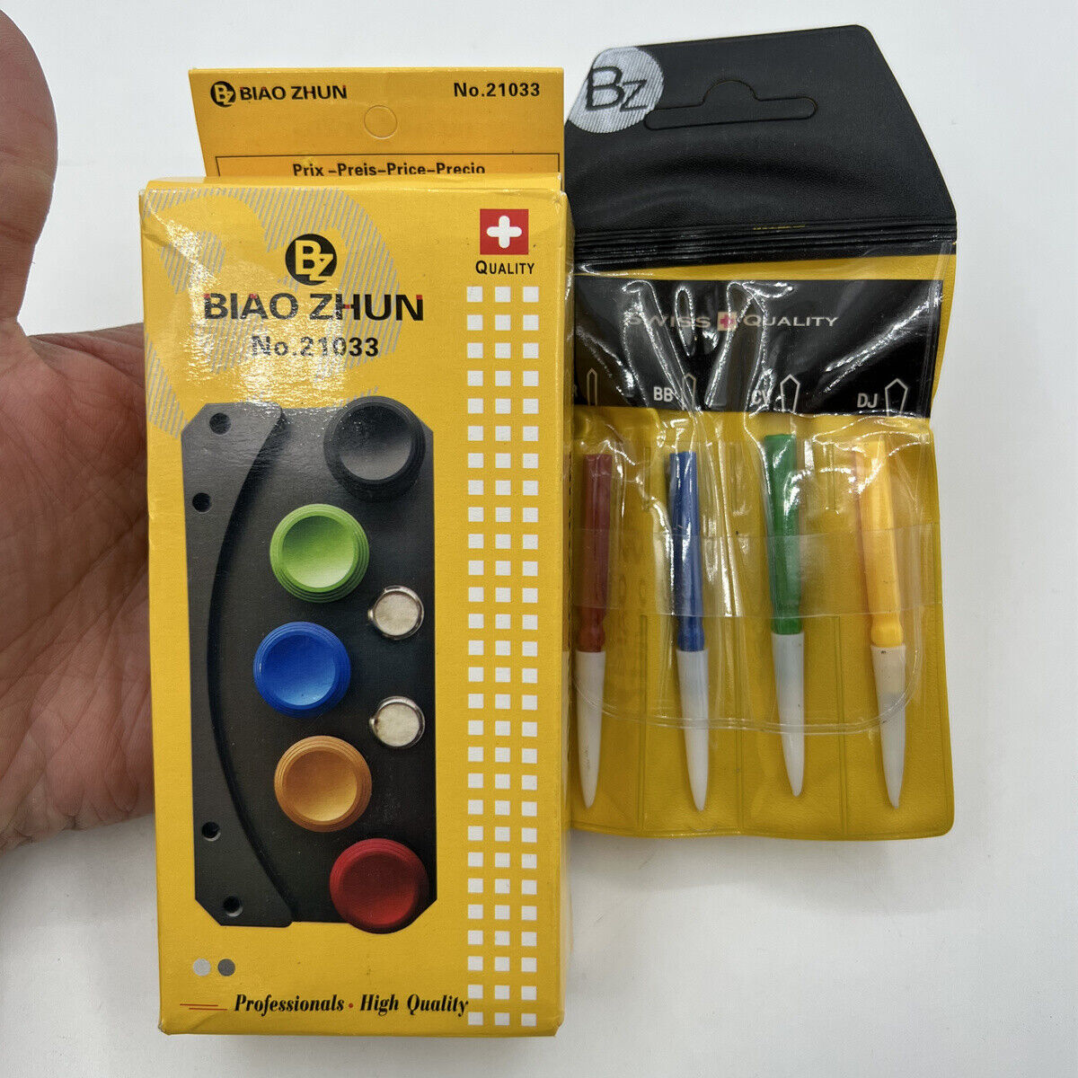 Silver oil cup stand with five die-cast alloy containers and an oiler pen for precise watch repair.