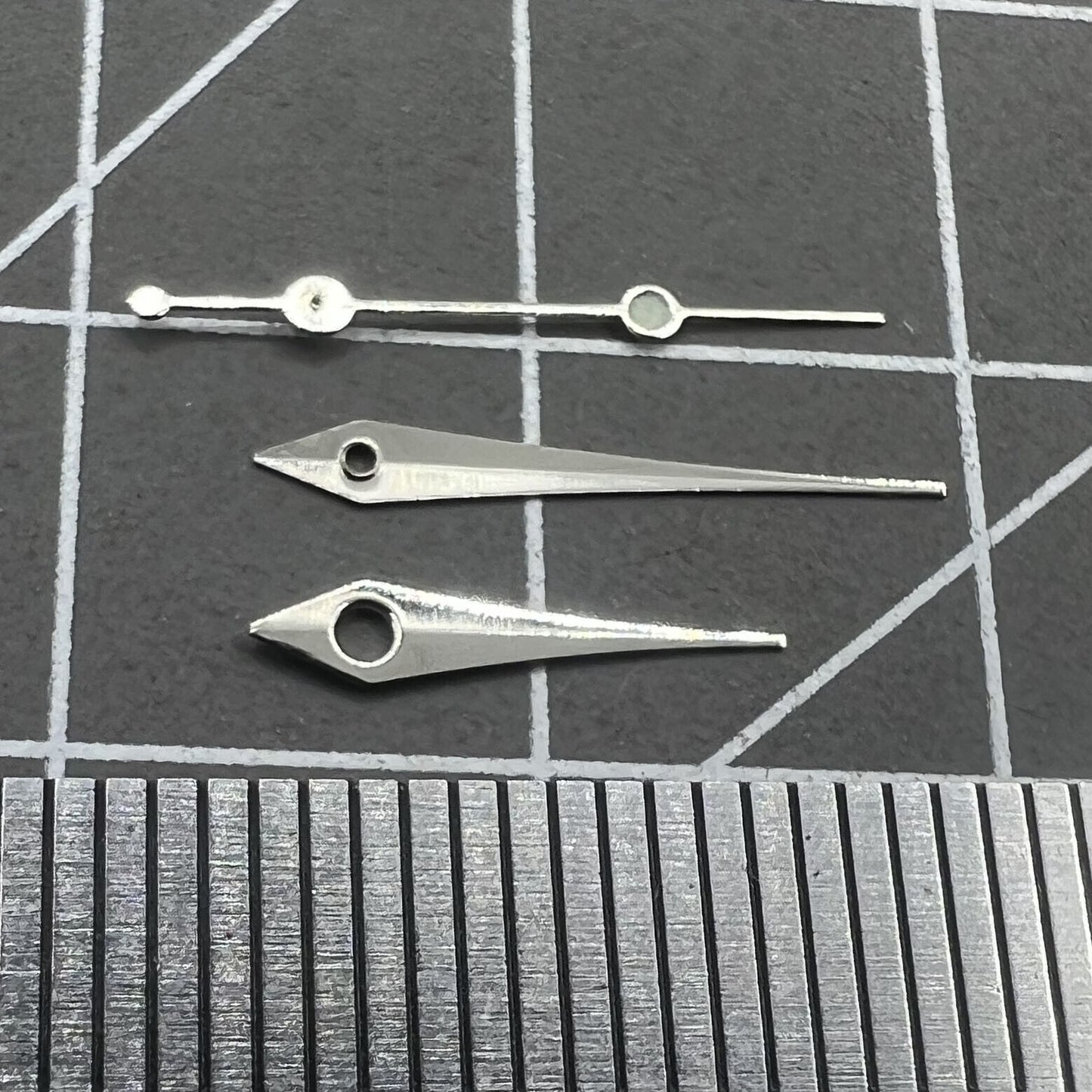 Silver 13mm arrow-shaped watch hands set by Trim, designed for Ronda 515 quartz movement timepieces.