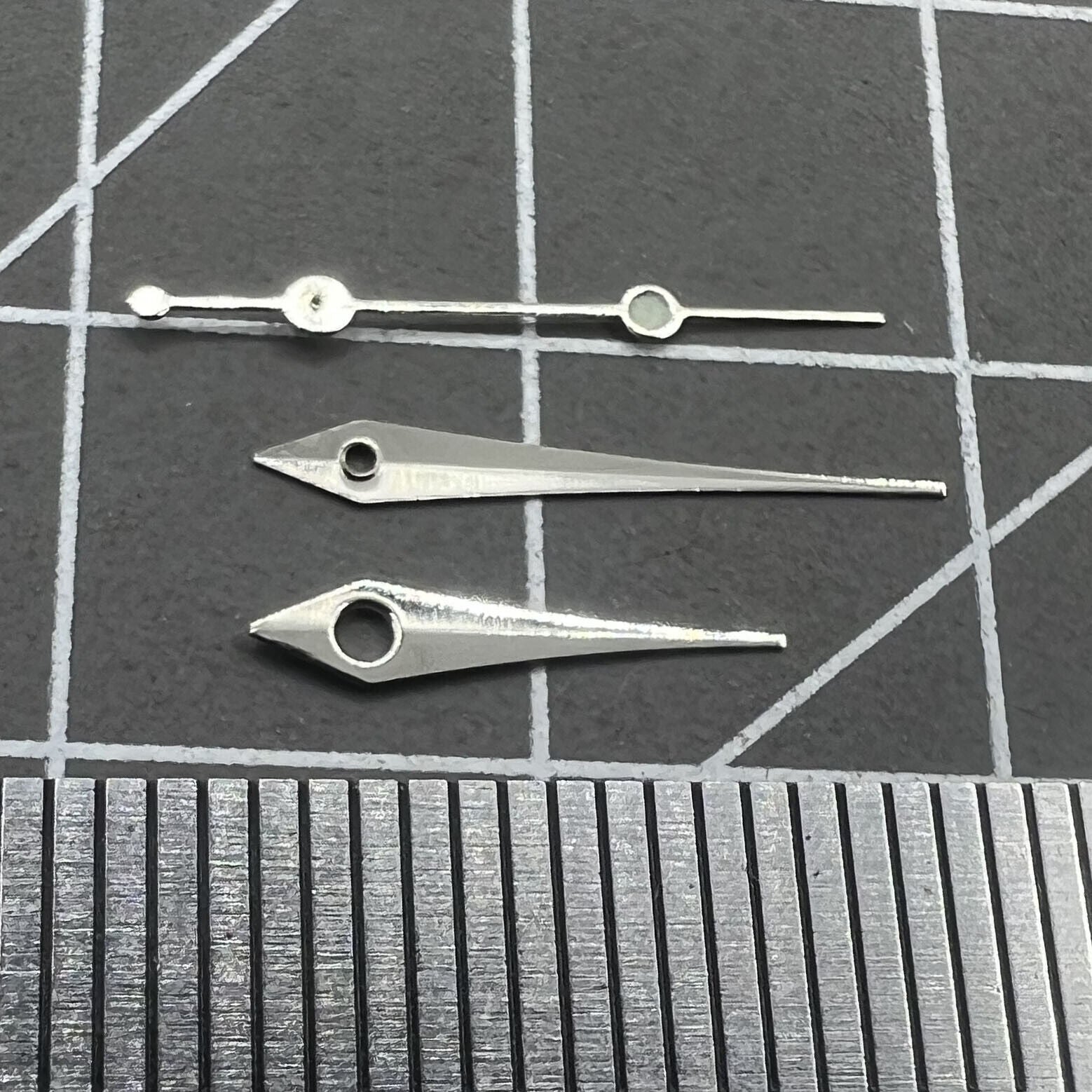 Silver 13mm arrow-shaped watch hands set by Trim, designed for Ronda 515 quartz movement timepieces.