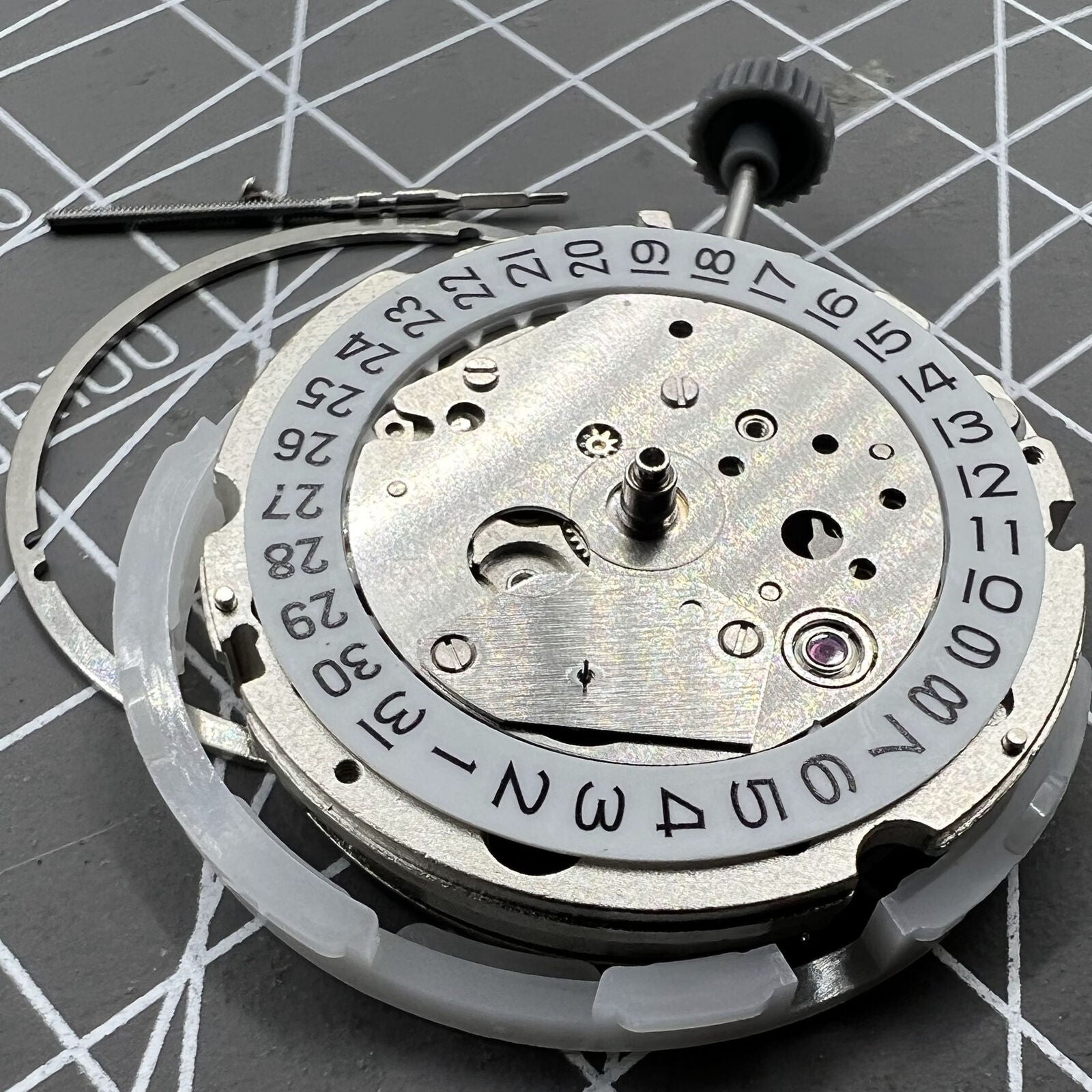 Miyota 8217 automatic watch movement showing 3 hands with small second at 9 o'clock position.