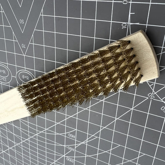 Copper wire brush with wooden handle for rust removal and metal cleaning in jewelry making