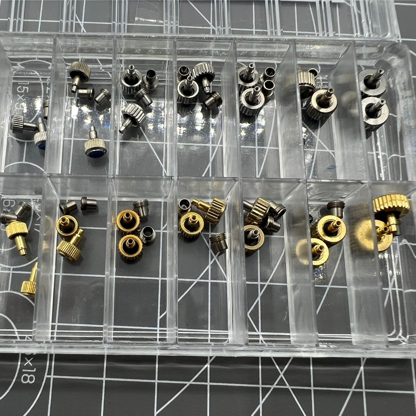 Stainless steel watch crown with silver and gold tones, screw-on tube, and gasket for secure fit.