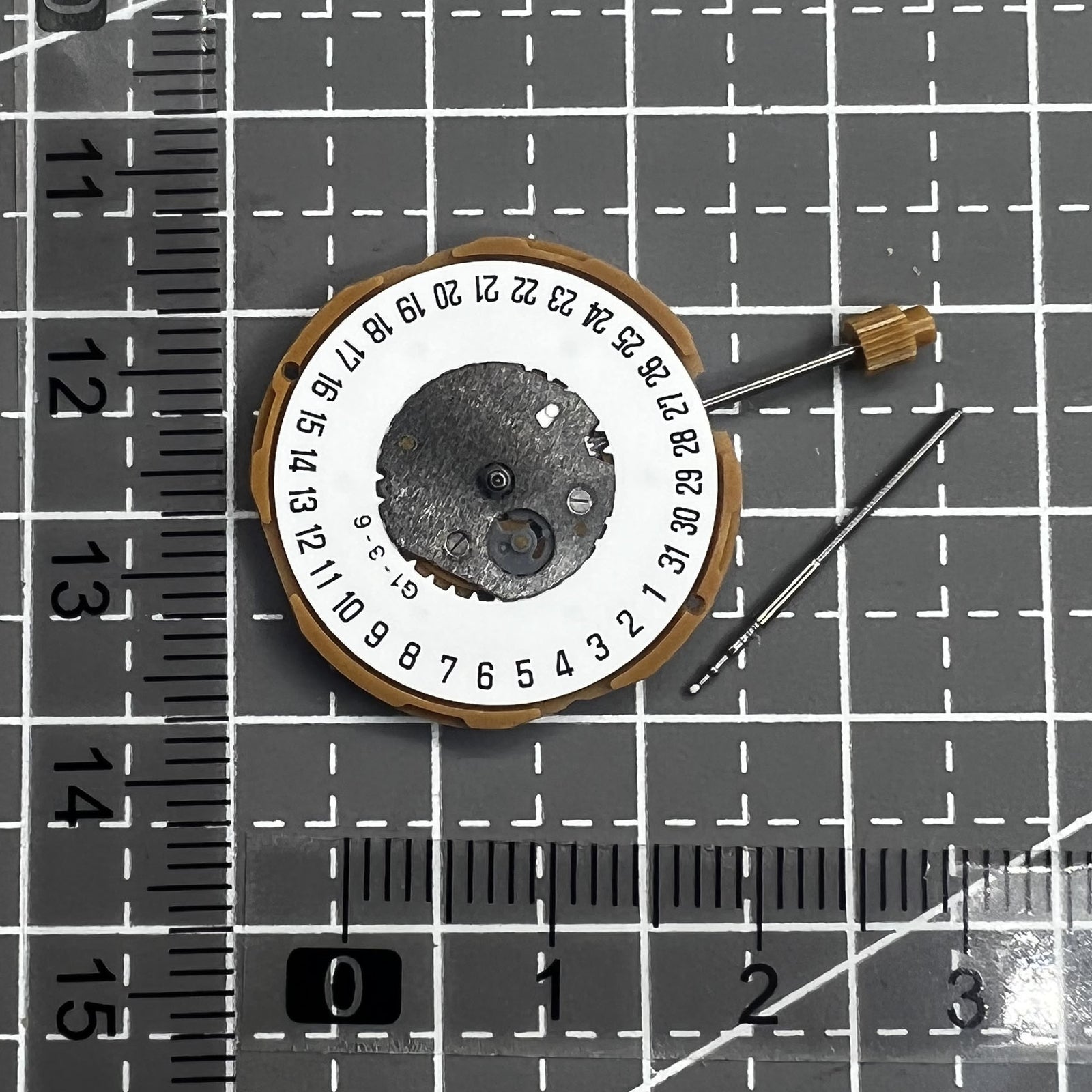 Japan Miyota GM10 watch movement with date display at 6 o'clock, precise quartz mechanism.