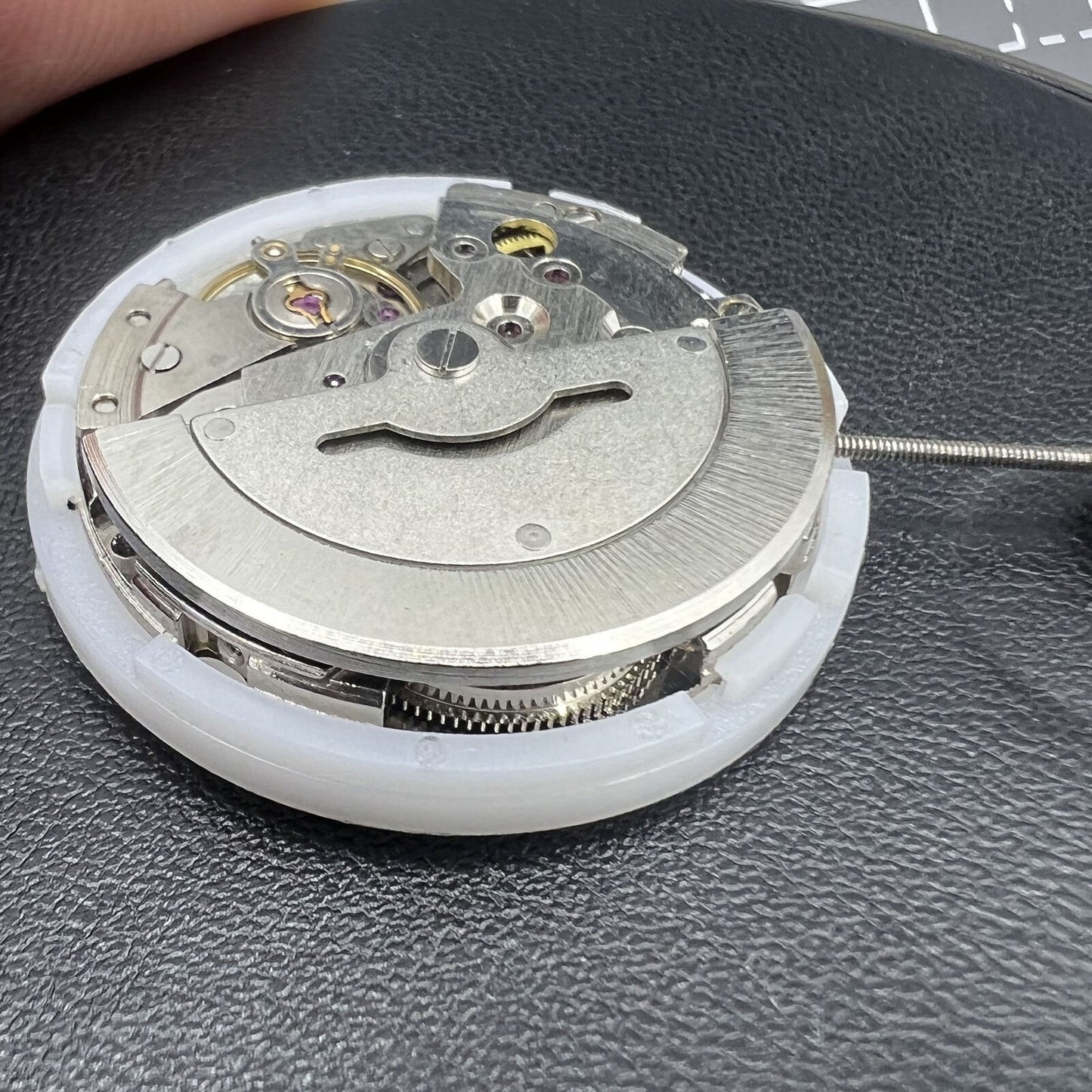 MINGZHU 2813 8205 silver automatic watch movement displaying day and date functions with intricate gears.