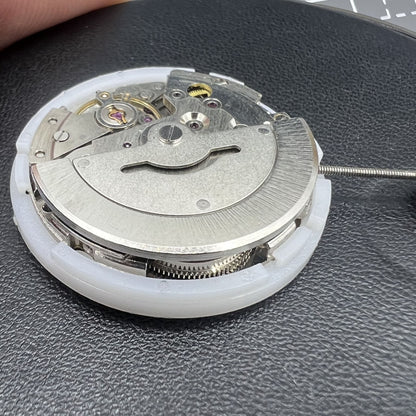 MINGZHU 2813 8205 silver automatic watch movement displaying day and date functions with intricate gears.