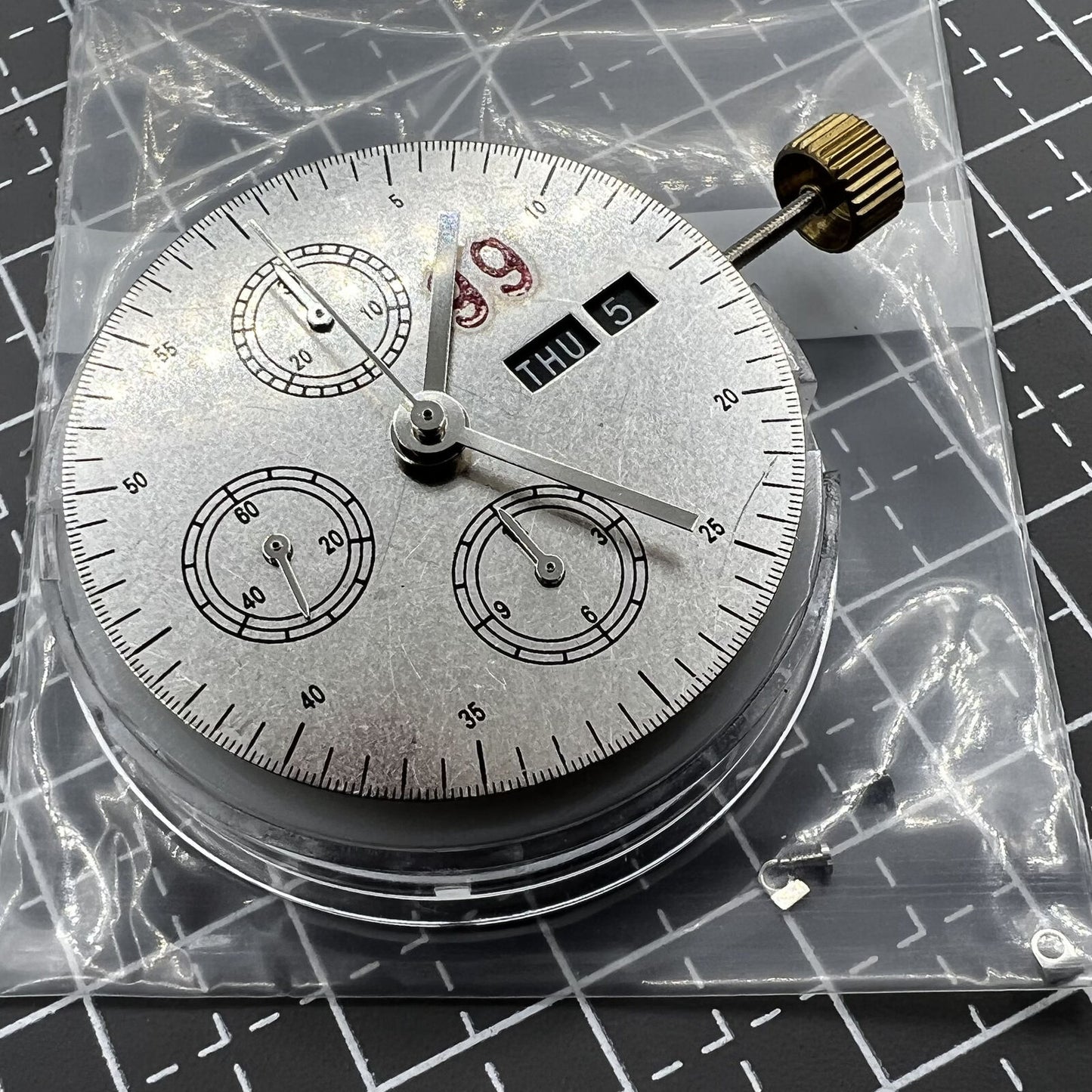 7750 black dial chronograph watch featuring three hands, small seconds at 9 o'clock, and day-date display for precise timekeeping.