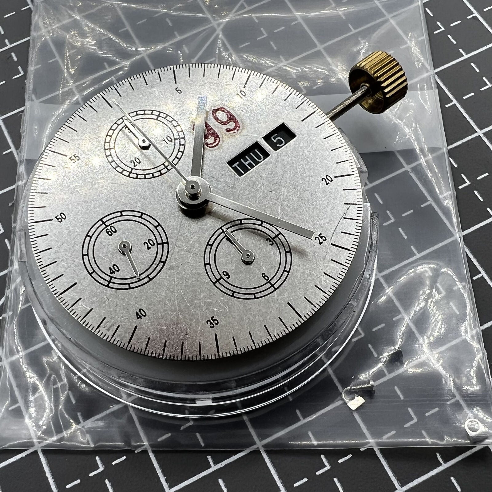 7750 black dial chronograph watch featuring three hands, small seconds at 9 o'clock, and day-date display for precise timekeeping.