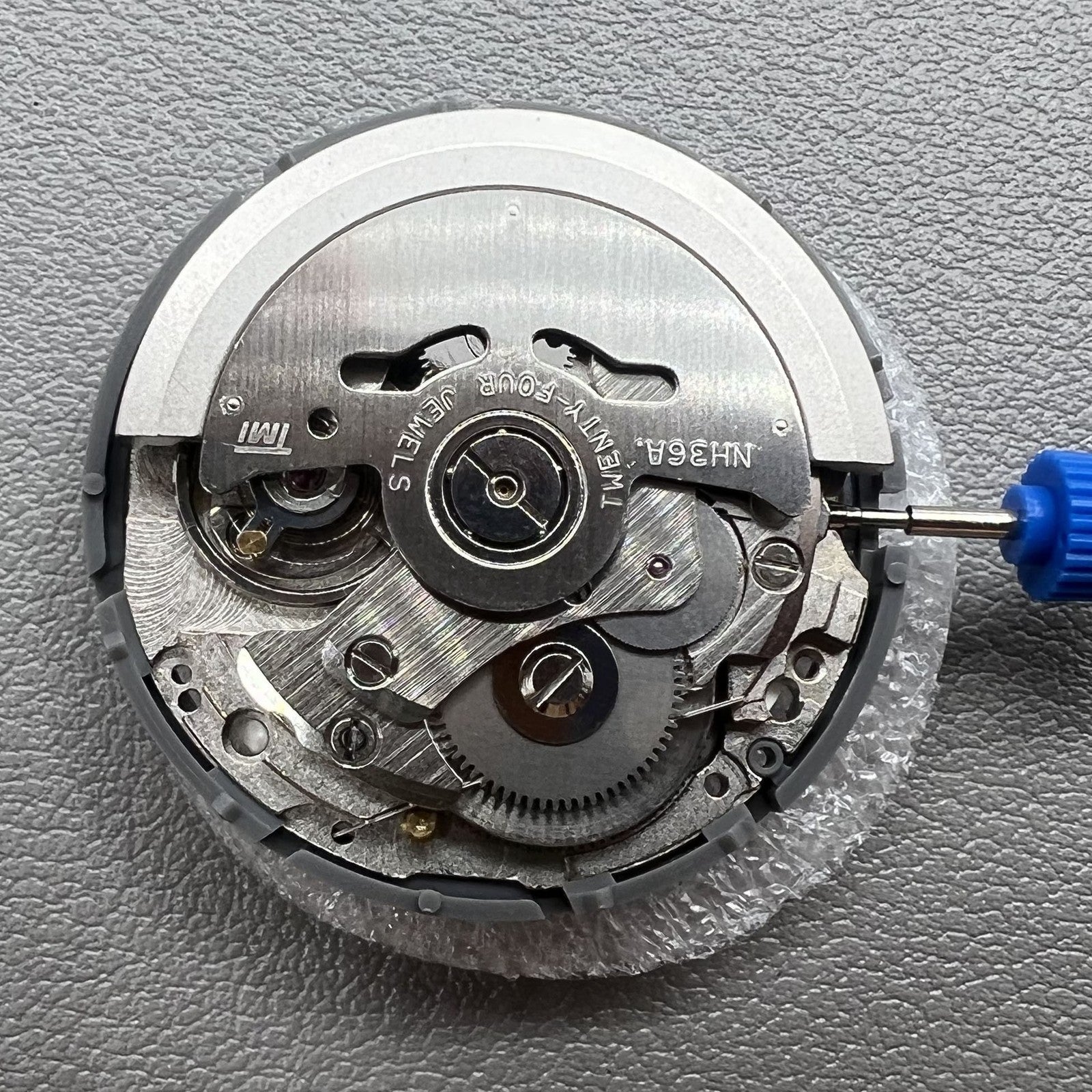 Seiki NH36 watch movement with white dial, featuring Japanese-English day display for precision timekeeping.