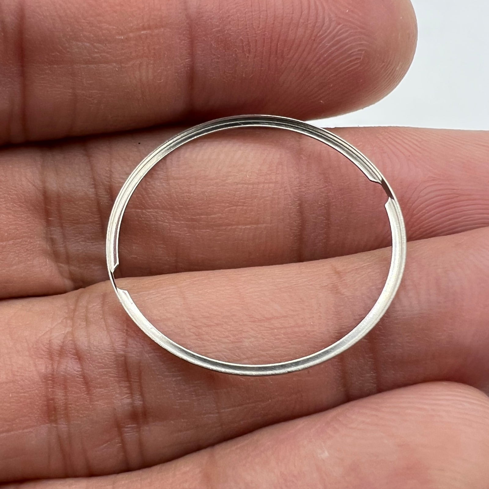 Steel spacer ring for ETA 2824 watch dial, ensuring precise alignment and secure fit.