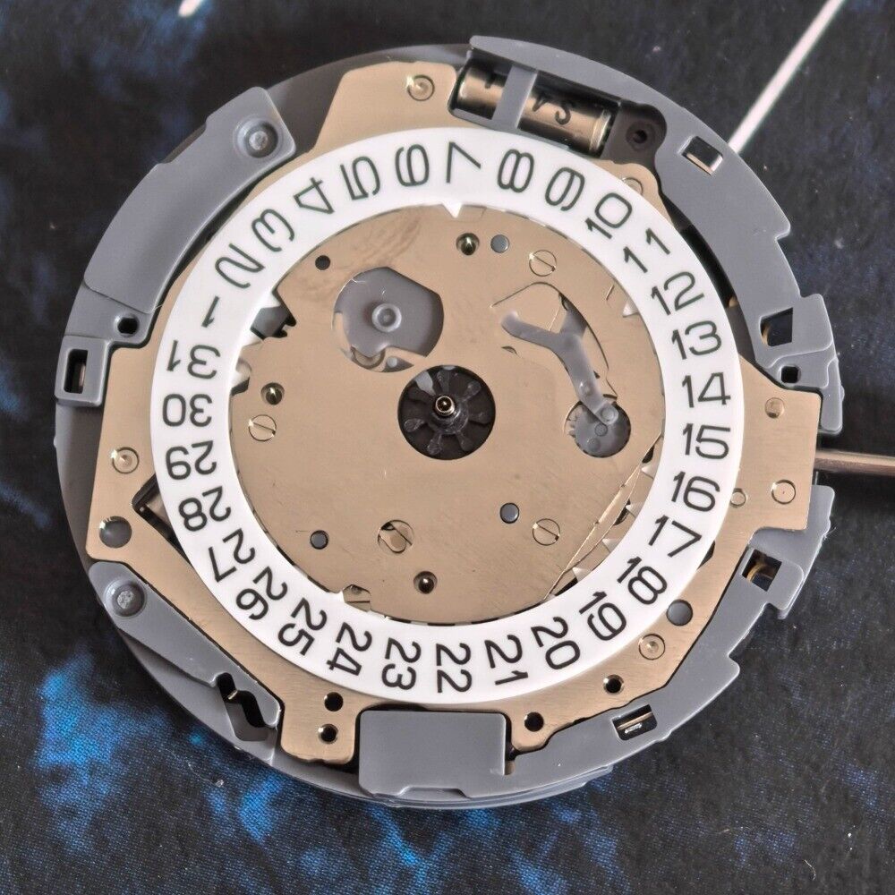 Miyota OS10 quartz watch movement with multifunctional 3 eyes and date display at 3 o'clock.