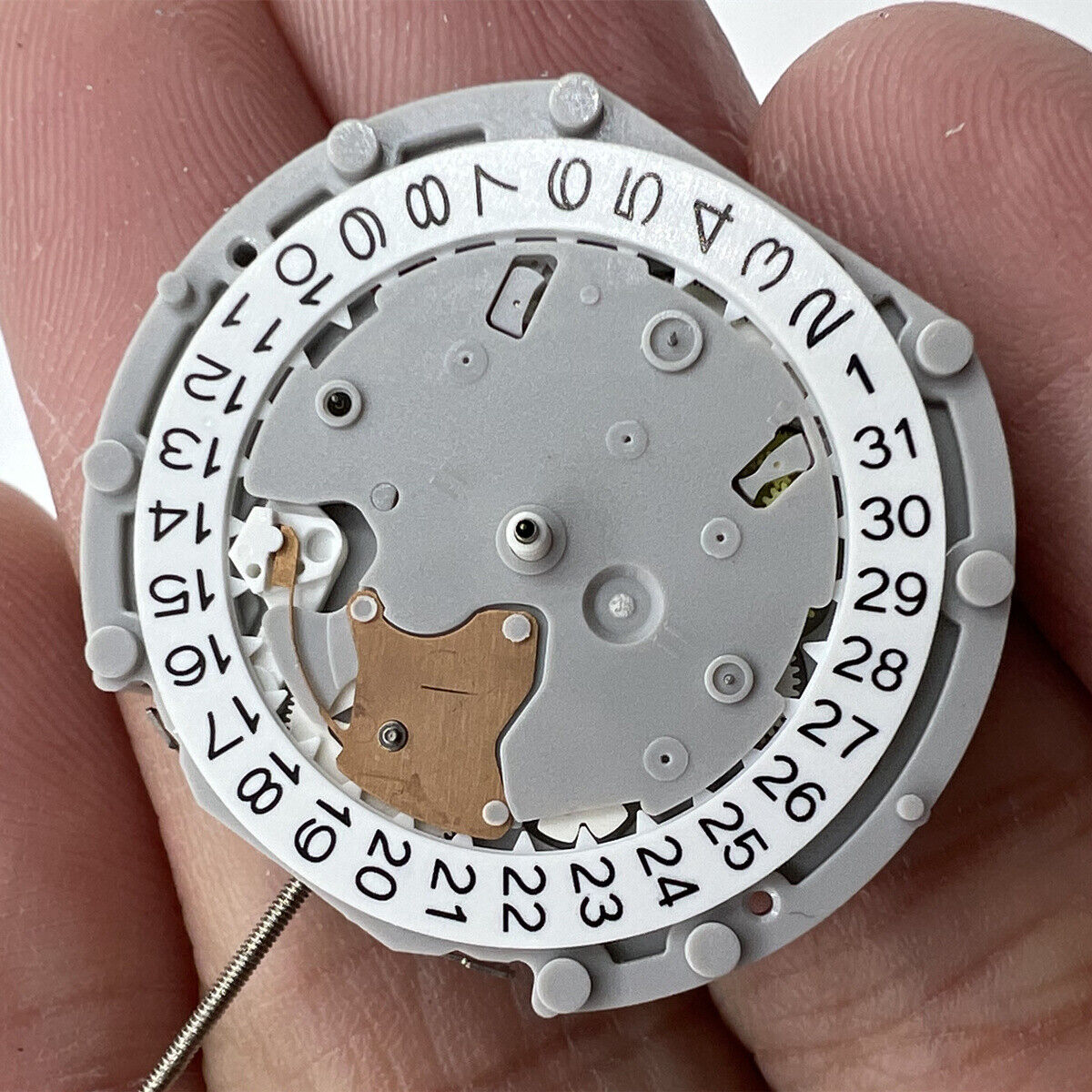 Sunon PE70 quartz watch movement with 3 hands and date display at 3 o'clock, small seconds at 6 and 9.
