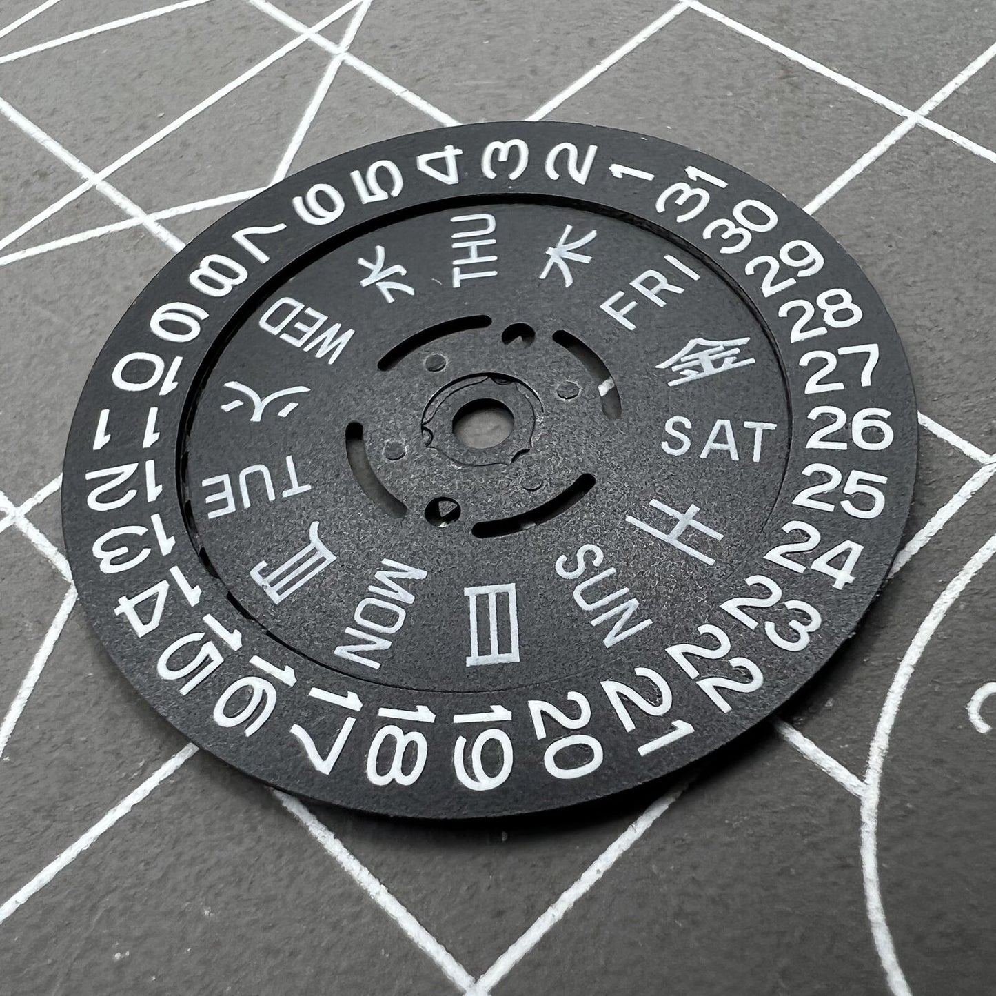 Blue Lume black date and week disk wheel for NH36 movement, enhancing watch accessory functionality.