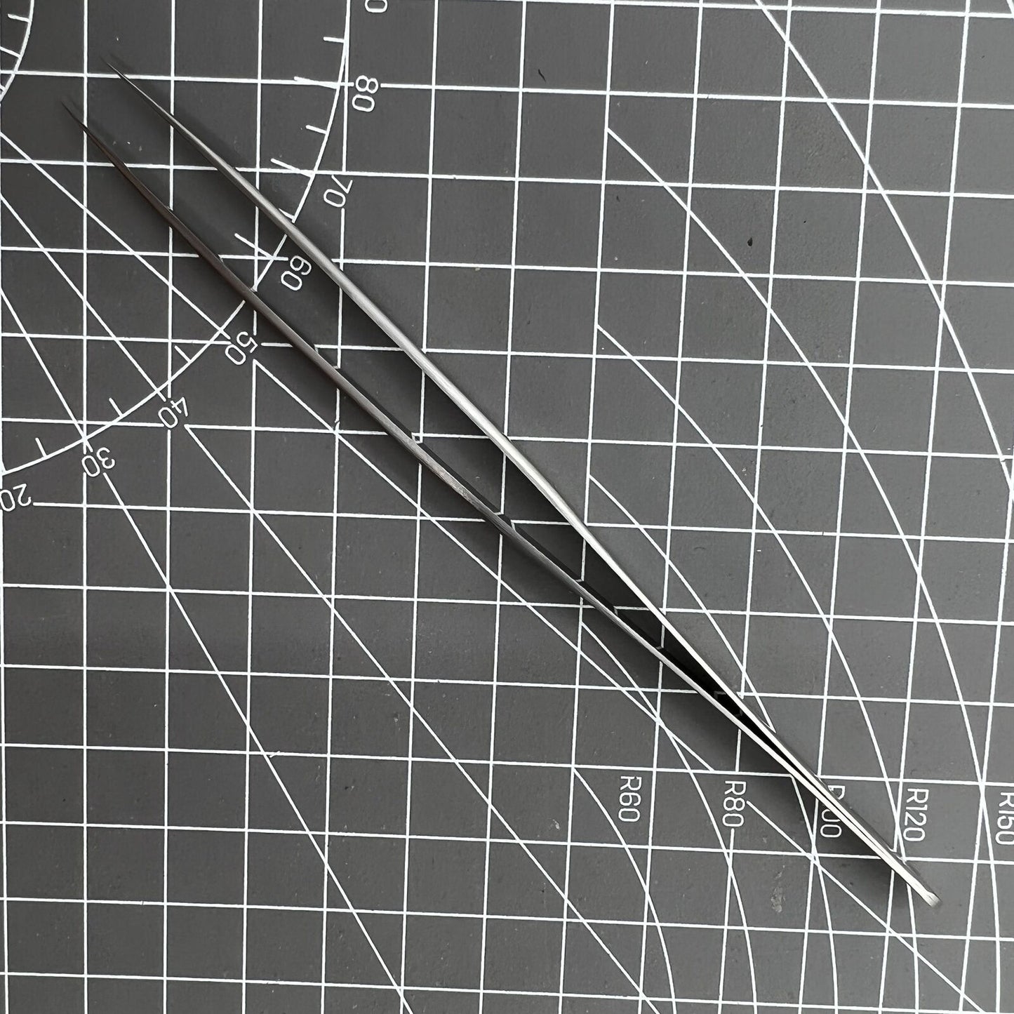 Swiss Made Bergeon 7027-SS tweezer with fine stainless steel tips for precise watch repair.